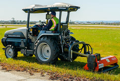 168玩家社区-im电竞俱乐部 Monarch Tractor mowing at an airport